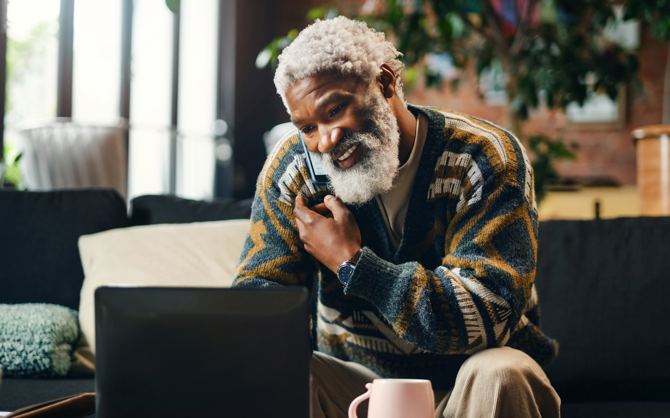 Senior man relaxing at home on a phone call